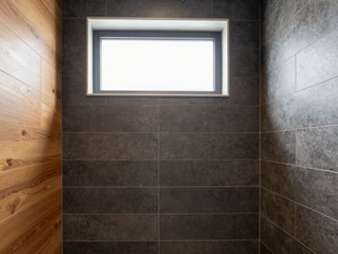 Architectural interior photography of a modern bathroom with precise charcoal tile alignment and warm integrated lighting, sharp focus, 35mm