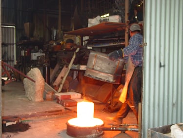 A glowing crucible full of bronze ready to pour