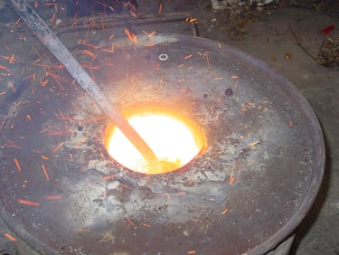Close up of the bronze in the crucible being stirred
