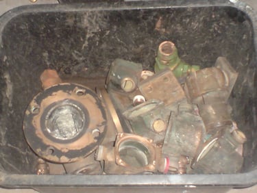 a container full of gunmetal odds and ends