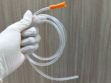 someone wearing gloves and holding a feeding tube
