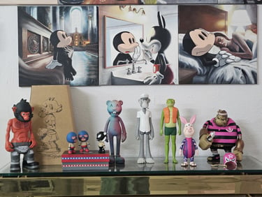 Mickey Mouse pop art paintings displayed above a collection of designer vinyl toy figures on a shelf.