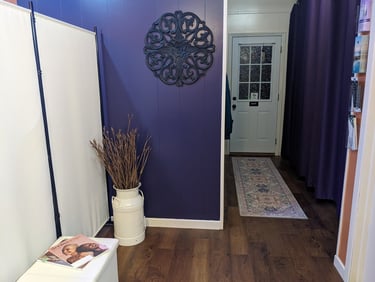 waiting area at Mud & Lotus Skincare, purple wall