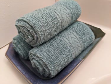 rolled up stack of light blue hand towels
