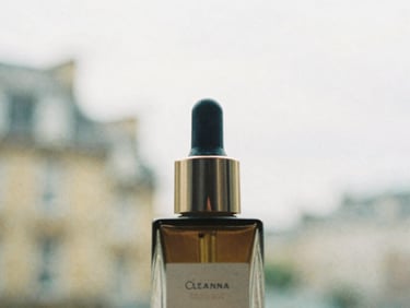 Close-up of a high-end beauty product with soft, diffused London daylight, shallow depth of field, off-center composition.