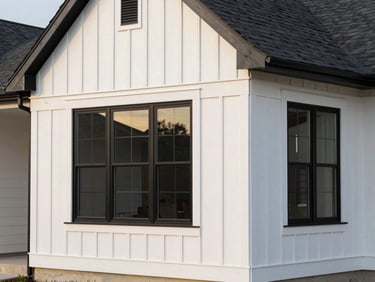Modern Edina home exterior featuring white LP SmartSide vertical board-and-batten siding contrasted with large black window frames, architectural lighting, sharp focus.