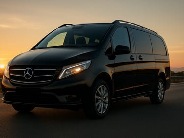 Low-angle heroic shot of a gleaming black Mercedes-Benz Vito on the Çeşme highway during golden hour, reflections of the Aegean sun on its polished surface, pristine and elegant.
