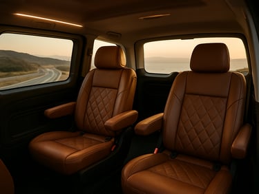 Interior of a luxury Mercedes Vito, leather seats, ambient warm lighting, spacious legroom, view of the Aegean highway through the window.