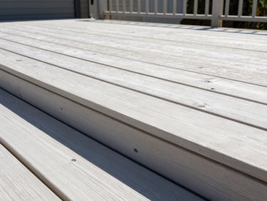 A close-up of a sharp timber repair on a residential deck under bright Perth sunshine