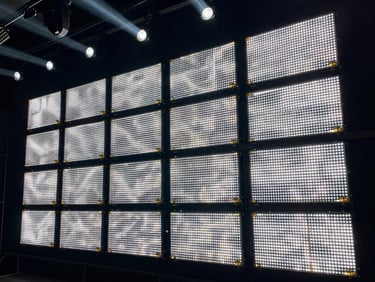 Macro shot of a high-resolution modular LED wall panel showing crisp pixel pitch and gold-plated connectors, dark industrial background, sharp stage lighting