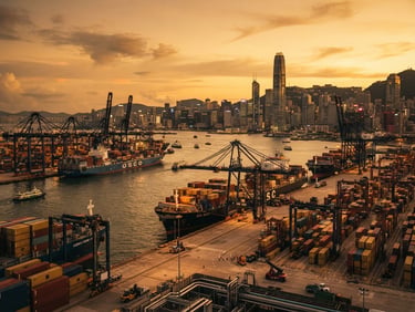 Wide environmental shot of Hong Kong harbor at dramatic golden hour, container ships docked, architectural lines of the port, cinematic 35mm, deep industrial tones.