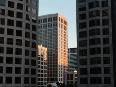 Architectural shot of Washington D.C. office buildings under cool daylight, clean geometric lines, professional corporate editorial, 35mm