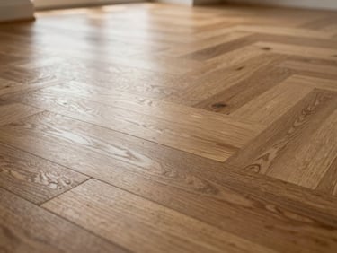 Close-up of perfectly sanded herringbone hardwood floor reflecting soft natural window light, flawless joints.
