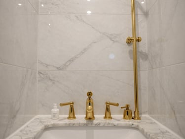Straight-on architectural elevation of a luxury bathroom with custom marble tile work and gold fixtures.