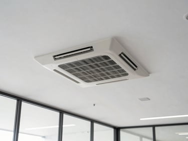 Bright modern corporate office interior with a clean ceiling cassette AC unit seamlessly integrated into the architecture.