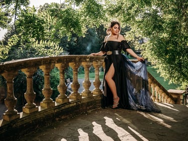 Model in black gown posing on stone stairs for a birthday photoshoot by Fred Art Studio.