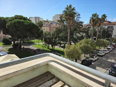 a view of a city street with cars parked in front of a building