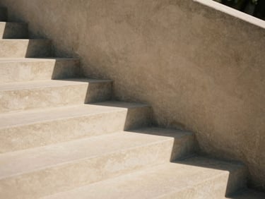 Minimalist architectural detail of concrete stairs and sharp shadows, warm sand tones, diffused natural daylight, high contrast, 35mm photography