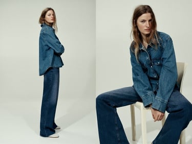 A woman wearing a double denim outfit with a blue jean shirt and wide-leg trousers.
