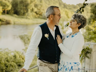 Elegant senior wedding couple gazing at each other by a river — fine art photography South of France