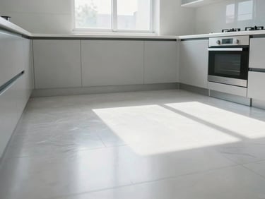 Clean, empty kitchen space after appliance removal, sunlight streaming through a window, sparkling clean floor.