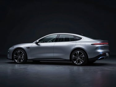 Sleek aerodynamic profile of a premium electric sedan in low-key studio lighting, cold blue highlights on the metallic silver chassis, dark background