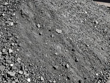 Close-up of graded hydraulic base material, mixed gravel and stone dust, high contrast texture.