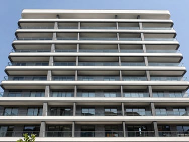 Wide-angle architectural photography of a modern luxury residential facade in Mexico City, clean straight lines, bright natural daylight, sharp focus