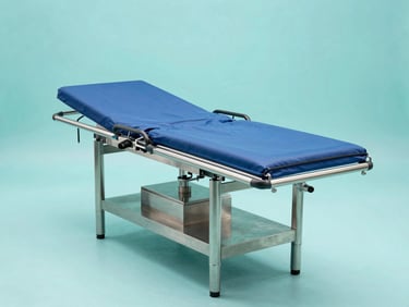 Straight-on product profile of a heavy-duty stainless steel operating table, bright cool studio lighting, clinical teal background.
