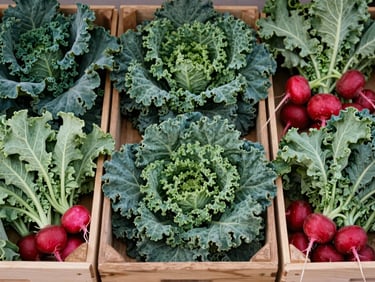 Overhead shot of wooden crates filled with freshly harvested green kale and red radishes, soft outdoor light