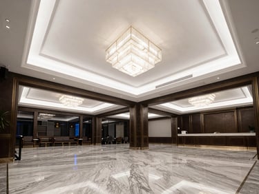 Interior of a luxury clubhouse lobby, polished marble floors reflecting cool-white architectural lighting, double-height ceiling with a geometric chandelier, dark walls with gold trim detailing, no people — wide architectural frame