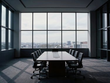 Modern corporate architecture interior, empty boardroom with a large conference table, cool overcast daylight streaming from tall windows, structured geometric shadows, desaturated navy and slate tones, architectural symmetry, 35mm