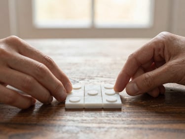 Macro shot of hands placing a white marble tic-tac-toe piece on a dark wooden table, soft morning light, cozy atmosphere