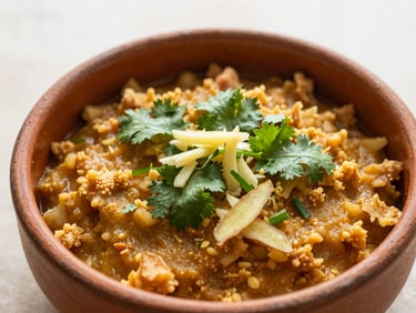 A top-down shot of a warm golden kitchari bowl garnished with fresh cilantro and grated ginger, morning light, earthy terracotta bowl
