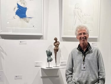 Santa Barbara artist Eric Saint Georges standing by his sculptures and drawings.
