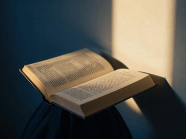 Person reading a devotional book in a quiet corner, soft morning light, deep blue and gold tones, soft focus, 35mm