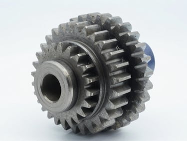 Close-up studio shot of a heavy-duty gear assembly, isolated on a clean white background, crisp technical lighting, cool gray and blue tones, sharp focus, 50mm.