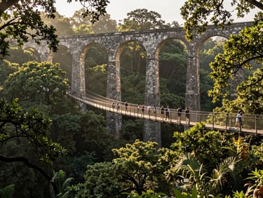 Active travelers walking along a suspension bridge near the top of Arcos del Sitio aqueduct, surrounded by lush green oak trees, soft morning light filtering through the forest canopy.
