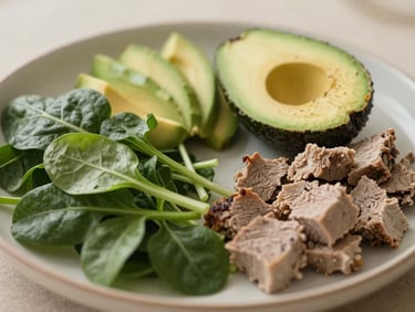 Warm editorial photograph, soft natural daylight, close-up of a plate with nutrient-dense whole foods like leafy greens, avocado, and lean protein, muted organic tones, shallow depth of field.