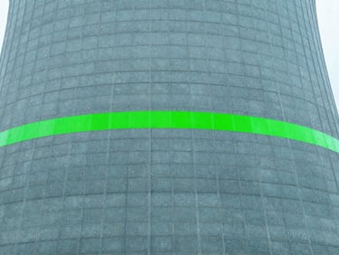 Close-up of a modern cooling tower fill material with water droplets, clean cool-toned daylight, sharp focus, safety green accents.