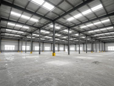 Panoramic view inside a large, newly constructed industrial warehouse, high ceilings, clean concrete floors, natural light flooding in from skylights.