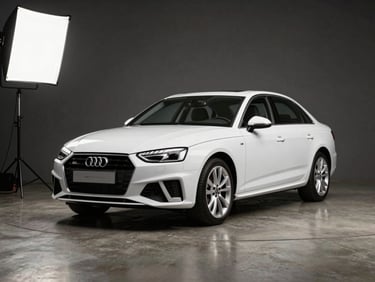Three-quarter front angle of a white Audi A4 on a polished concrete studio floor, bright studio strobes, clean dark neutral backdrop, no people