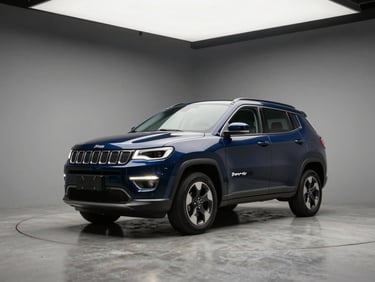 Three-quarter front angle of a midnight blue Jeep Compass on a matte concrete studio floor, clean overhead studio lighting, neutral grey backdrop, no people
