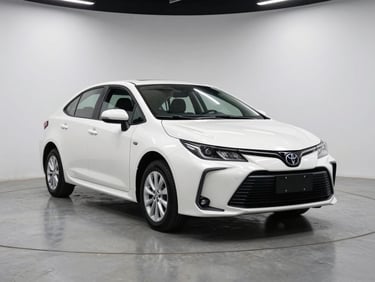 Three-quarter front angle of a pearl white Toyota Corolla on a matte concrete studio floor, bright overhead strobes, clean light neutral backdrop, no people