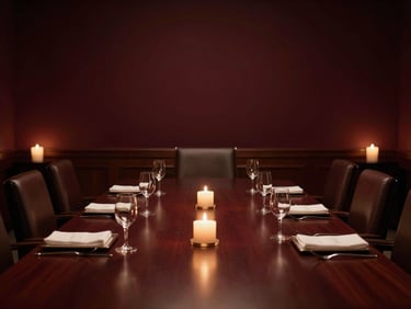 An elegant executive boardroom dining setup with warm candlelit accent lighting, deep shadows, architectural lines
