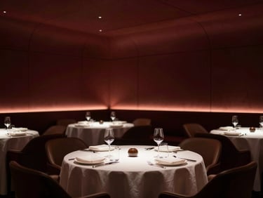 A luxury private dining room with warm architectural spotlighting, minimalist table settings, refined luxury atmosphere