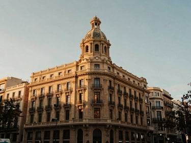 Wide shot of premium Passeig de Gracia district in Barcelona, elegant classic buildings, soft golden-hour light, 35mm