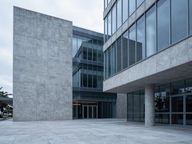 Wide architectural perspective of a minimalist concrete and glass corporate office lobby in Buenos Aires, cool blue overcast light, sharp focus, 35mm lens