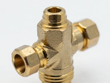 Extreme close-up macro shot of a brass diverter cartridge, showing intricate machining details and polished surface, clean studio lighting, high-contrast cool tones.