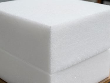 Stack of dense white polyethylene foam sheets cut to precise square dimensions